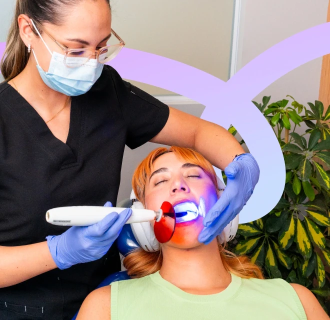 Dentist curing a composite tooth filling during treatment in Mexico City.