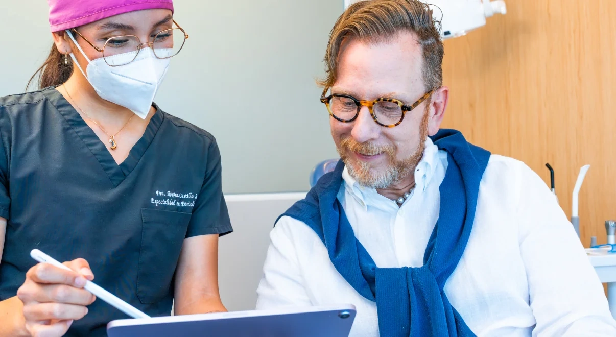 hisonrisa dentist reviewing the definitive bridge plan with a patient during the second All-on-4 trip.