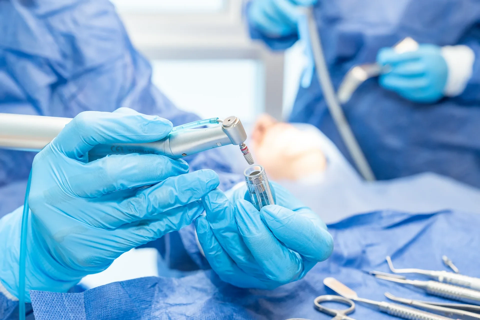 Close-up of a clinician holding an implant driver during dental implant treatment planning