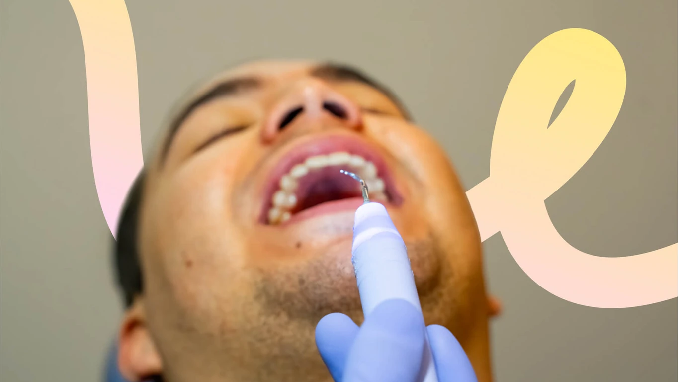 Dental scaler removing tartar during a professional cleaning.