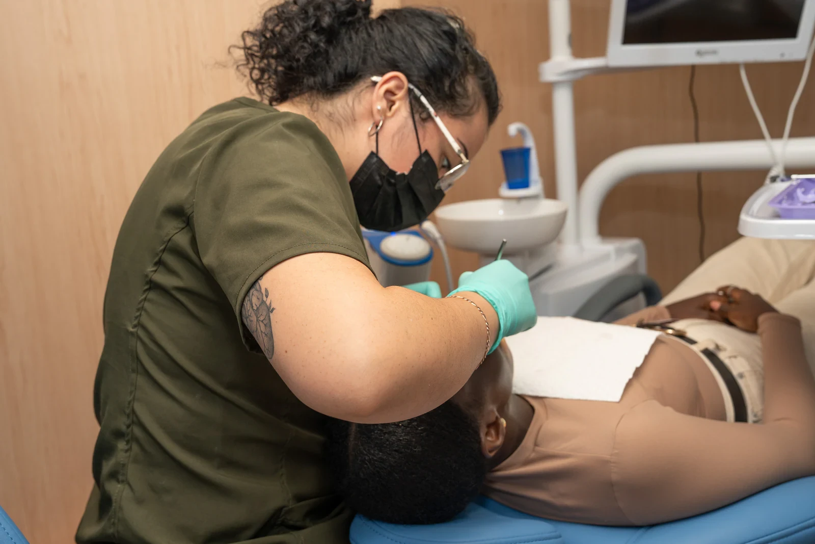 Dentist performing a clinical oral examination as part of a dental implant evaluation.