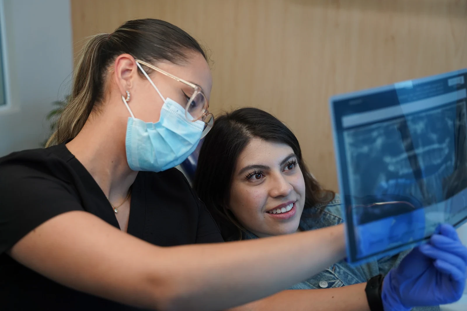 Dentist and patient reviewing a panoramic radiograph as part of implant planning.