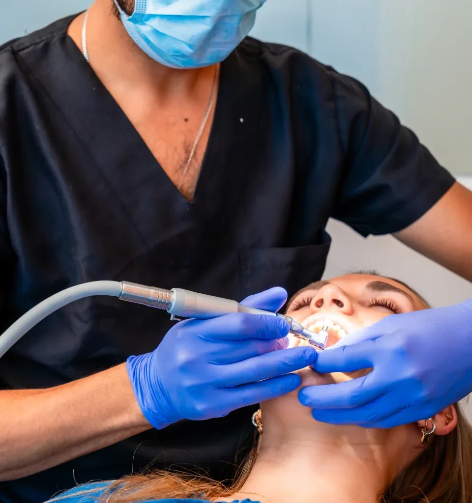 Dentist performing a preventive dental cleaning for a patient.
