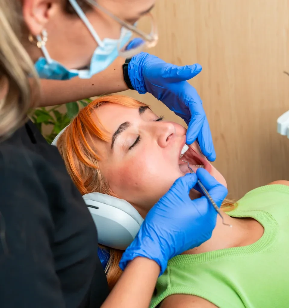 Dentist examining a patient with tooth pain during an evaluation.
