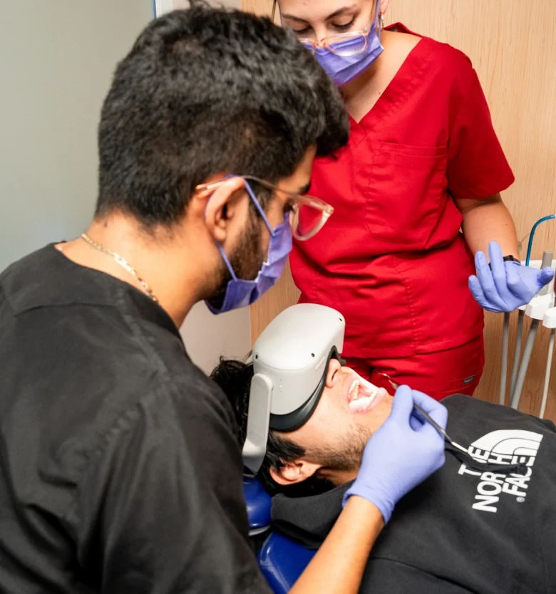 Two clinicians treating a patient at hisonrisa in Roma Sur.