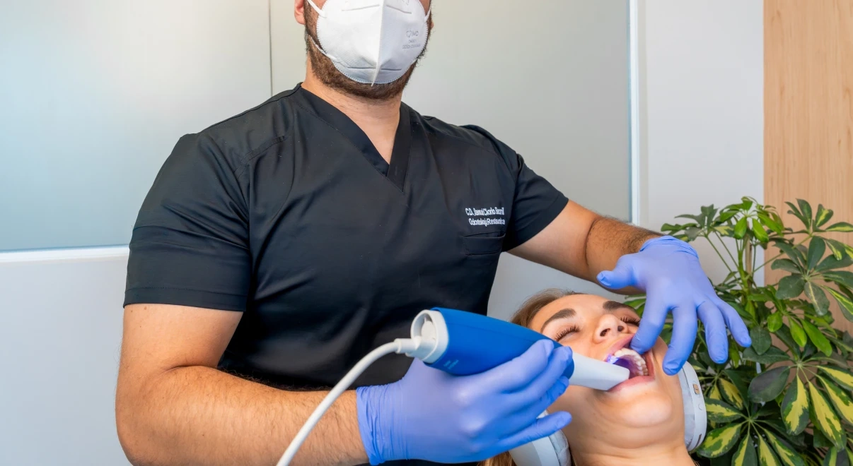 Dentist taking a digital scan for a custom 3D occlusal night guard.