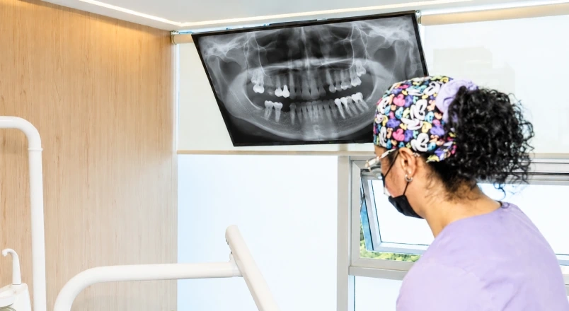 Dentists reviewing a panoramic X-ray before planning a removable denture.