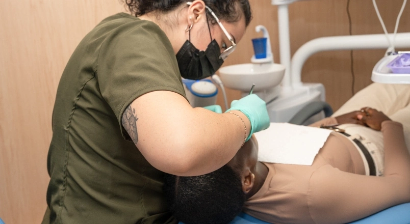 Dentist checking a tooth before deciding whether it needs a crown after root canal treatment.